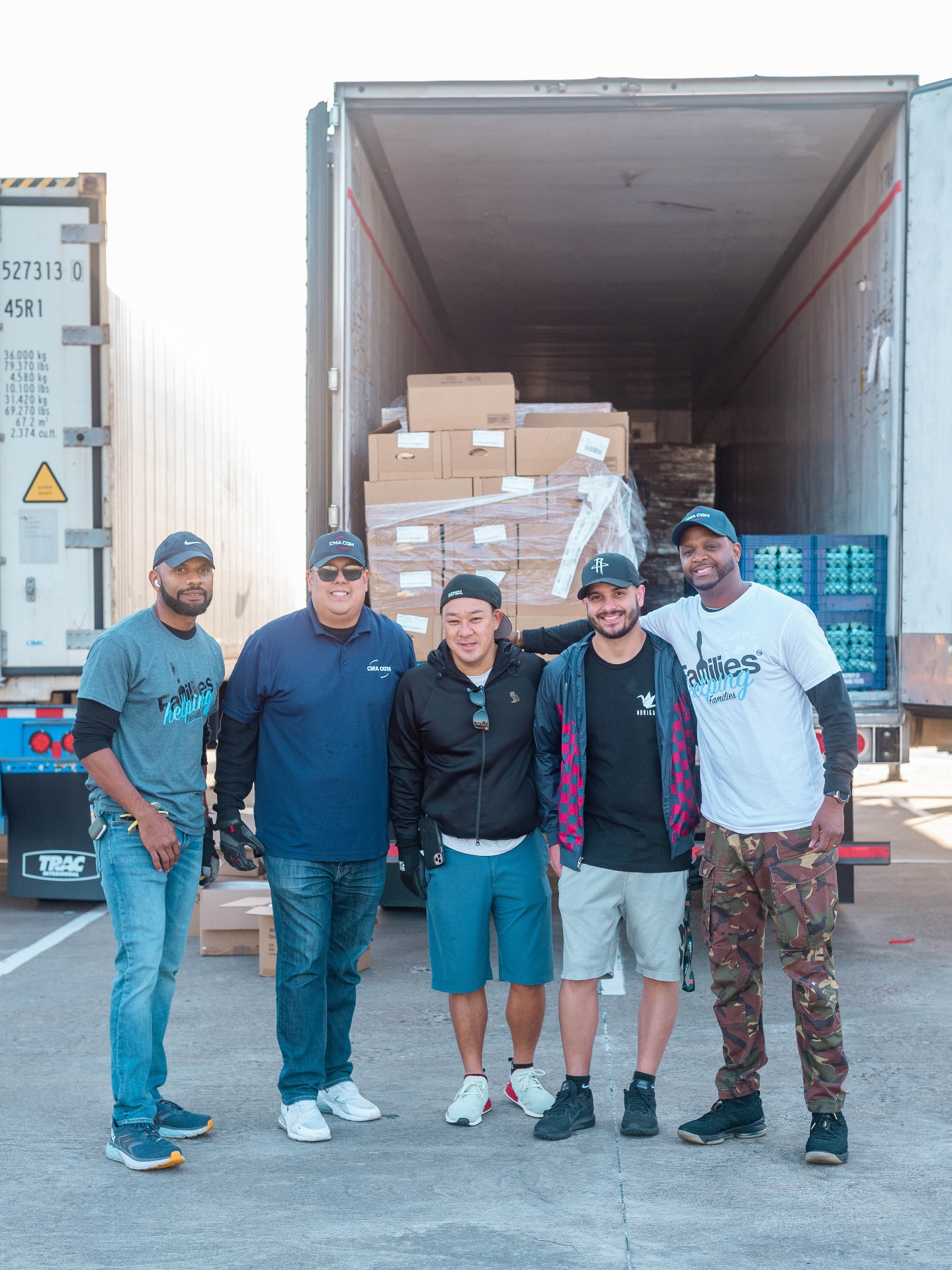 Volunteer team standing in front of food donation truck