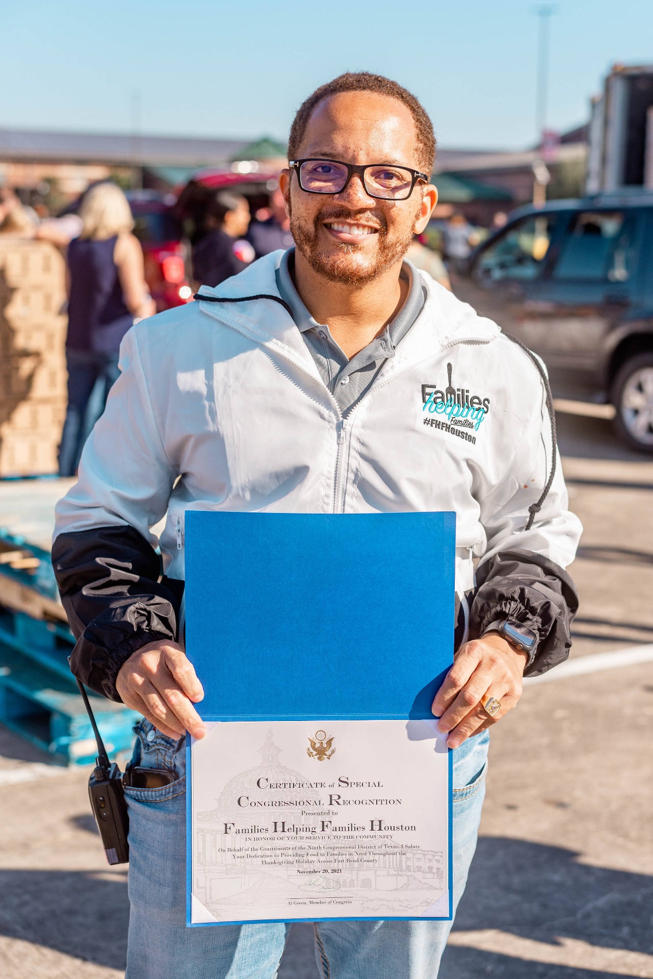 Volunteer holding recognition certificate